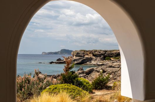 View out of an archway at the rocky coastline at Kallithea Therms, Kallithea Spring on Rhodes island, Greece