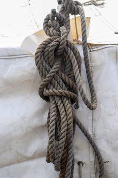 Detailed close up detail of ropes and cordage in the rigging of an old wooden vintage sailboat.