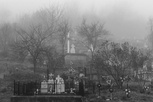 A creepy cemetery with black and white fog
