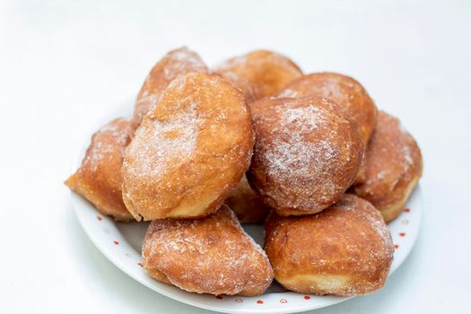 Homemade donuts full of sugar on the plate