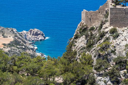 Panoramic view at landscape and coastline near Monolithos on Greek island Rhodes with the aegaen sea in the background and old ruins with church on a hill