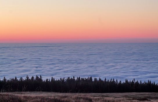 The sunset surrounded by fog, from the top of the mountain