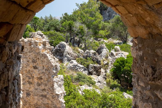 Scenic view through an archway of castle Asklipio at rocks on a mountain