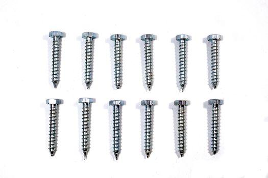 A set of new screws on a white background