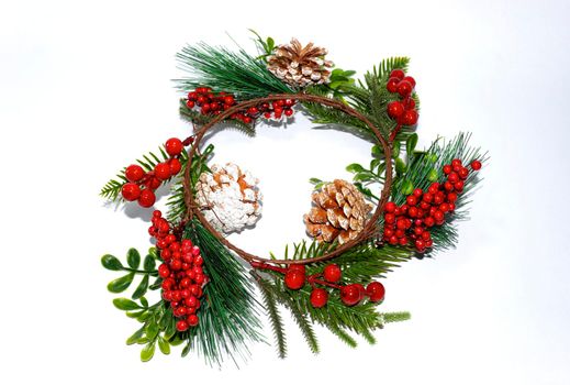 Decorative Christmas wreath with berries and cones