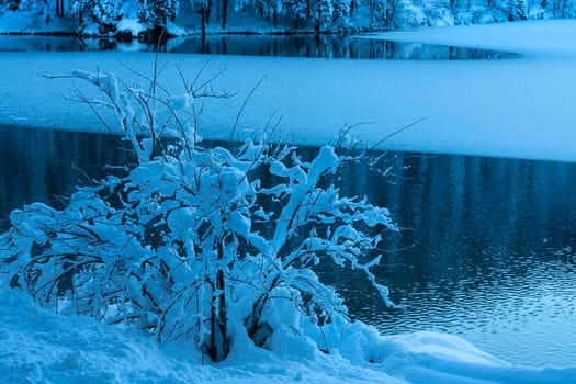 the panorama of the lake of Fusine, Tarvisio, frozen in winter