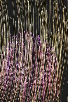 Rays of abstract lights on a black background, with different colors and thicknesses, as well as effects of movement, vibration and transformation.