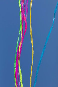 Rainbows of abstract moving lines, in vivid colors, formed by wrinkled fabrics that float lightly on a plain-colored background.