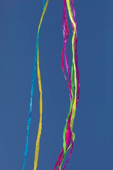 Rainbows of abstract moving lines, in vivid colors, formed by wrinkled fabrics that float lightly on a plain-colored background.