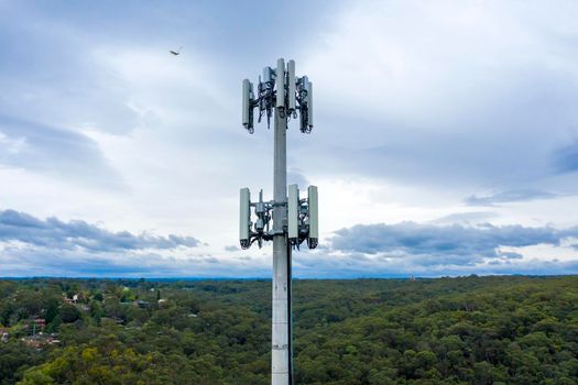 Aerial view of a communications tower in a forest in regional Australia