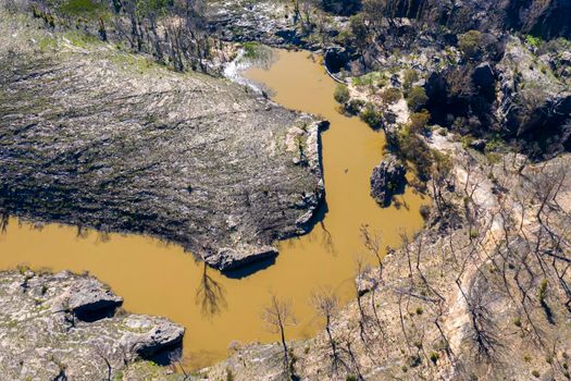 Aerial view of a water reservoir surrounded by forest regeneration after bushfires in Dargan in the Central Tablelands in regional New South Wales Australia