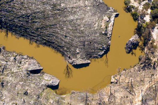 Aerial view of a water reservoir surrounded by forest regeneration after bushfires in Dargan in the Central Tablelands in regional New South Wales Australia