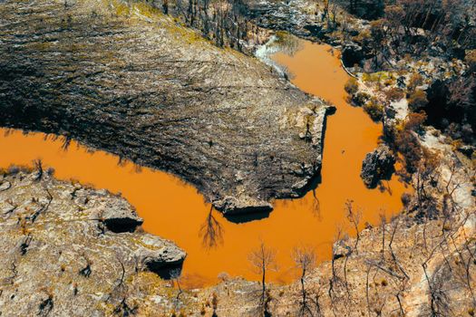 Aerial view of a water reservoir surrounded by forest regeneration after bushfires in Dargan in the Central Tablelands in regional New South Wales Australia