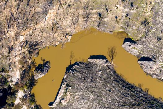 Aerial view of a water reservoir surrounded by forest regeneration after bushfires in Dargan in the Central Tablelands in regional New South Wales Australia