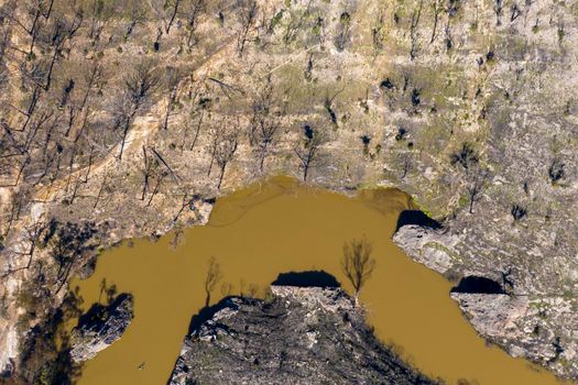 Aerial view of a water reservoir surrounded by forest regeneration after bushfires in Dargan in the Central Tablelands in regional New South Wales Australia