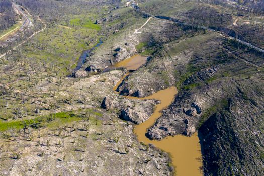 Aerial view of a water reservoir surrounded by forest regeneration after bushfires in Dargan in the Central Tablelands in regional New South Wales Australia