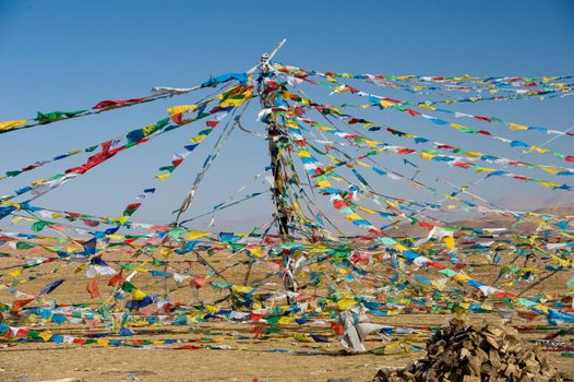Colored rags on a rope in Tibet. Rituals and beliefs.