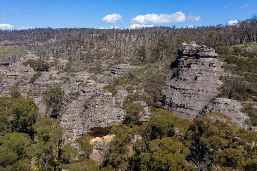 Aerial view of forest regeneration after bushfires in a large valley in the Central Tablelands in regional New South Wales in Australia