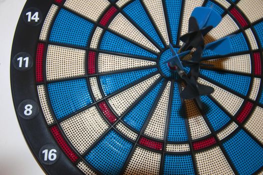 Dartboard with darts in the center, closeup