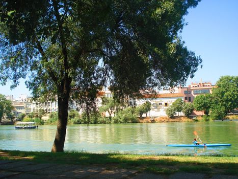 Guadalquivir river with canoe in summer time