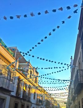 Street decorated of garlands for the holidays, summer, Seville, Spain