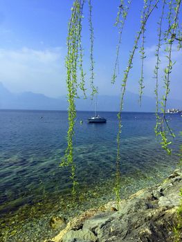 Small yacht at blue lake, spring, Lago di Garda, Italy