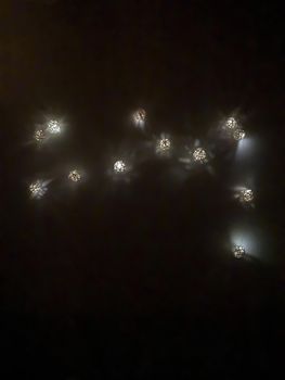 Garland of small decorative luminous balls, night time