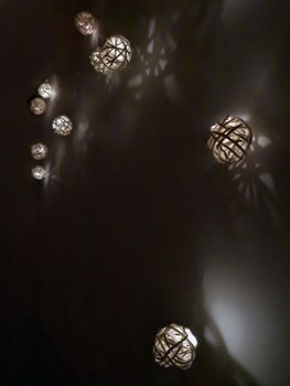 Many small decorative luminous balls on the wall, right view, night time