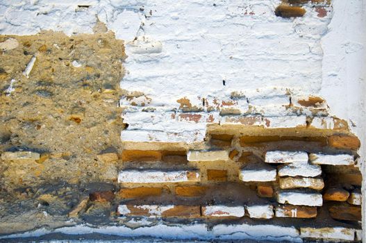 White brick wall with different structured surface