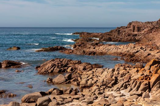 The brown Rocks and blue water of the Tasman Sea at Birubi Point near Port Stephens in regional New South Wales in Australia