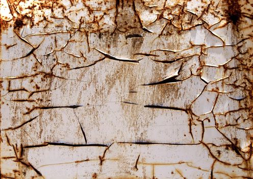 Old rusty iron wall covered with white flaked paint, Portugal beach