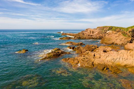 Aerial view of the brown Rocks and blue water of the Tasman Sea at Birubi Point near Port Stephens in regional New South Wales in Australia