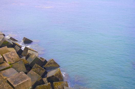 Blue sea and cubic bricks, summer