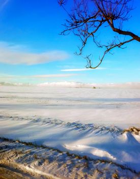 Fields of snow and blue sky in the road to Prague, winter, morning time