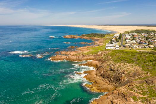 Aerial view of the Stockton Sand Dunes and blue water of the Tasman Sea at Birubi Point near Port Stephens in regional New South Wales in Australia