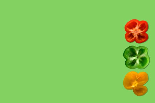 Red, green, yellow peppers in the light green background