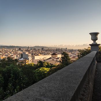 Barcelona (Spain) urban skyline. A view over the rooftops of El Poble-Sec District and the skyscrapers of the most modern neighborhoods in the background. The photo has been taken at morning from a terrace close to the park at the Palau Nacional (National Palace).