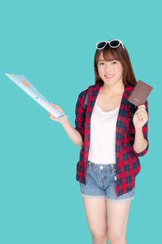 Beautiful portrait young asian woman wear sunglasses on head smile excited and enjoy summer holiday isolated blue background, girl hipster cheerful holding passport and map for travel trip concept.
