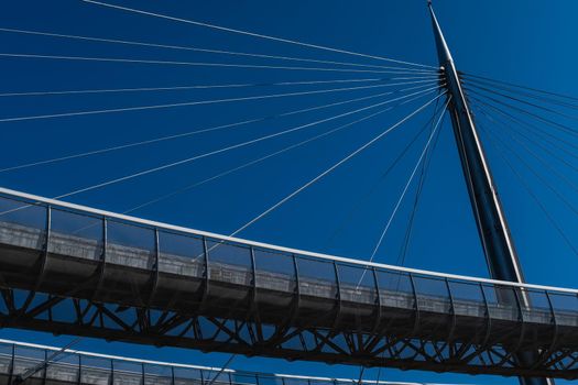 Low angle view of the Ponte del Mare in Pescara (Italy), a cable-stayed bridge whose structure is made up of two separate ways, a bicycle path and a footpath. This bridge connects the south coast with the north of the river Pescara.