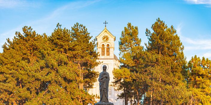 Church in Montenegro with statue of virgin Mary with Christ. Travel in Europe.