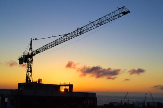 Silhouette of a construction crane against the sunset in Antofagasta, Chile