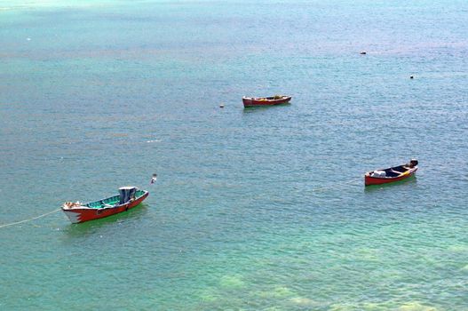 Three fishing boats on the turquoise waters of Juan Lopez, Antofagasta, Chile.