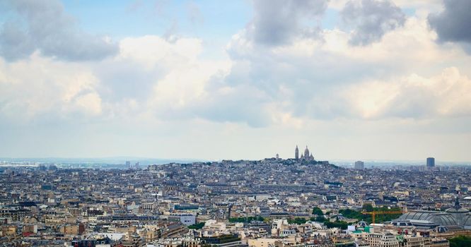 The city of Paris, from the second platform of the Eiffel Tower. In the distance, the Basilica of the Sacred Heart can be seen.