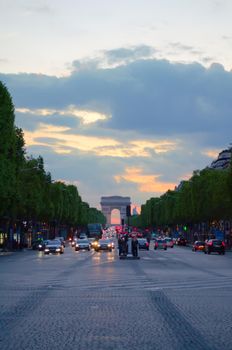 View of the Arch of Triumph at evening, in Paris, France.
