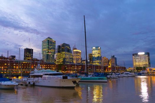 Luxury yachts anchored in Puerto Madero, in the city of Buenos Aires, at dusk.