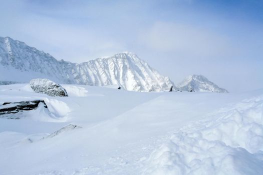 Baikal mountains in winter in snow. Forest in snow-covered mountains.