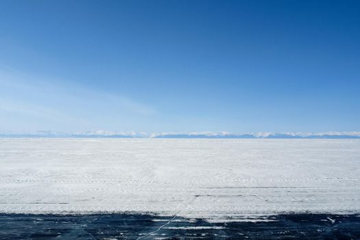 Baikal mountains in winter in snow. Forest in snow-covered mountains.