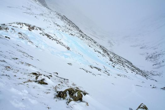 Baikal mountains in winter in snow. Forest in snow-covered mountains.