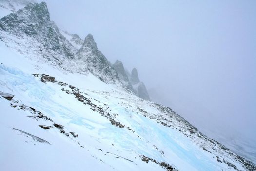 Baikal mountains in winter in snow. Forest in snow-covered mountains.