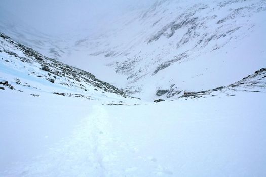 Baikal mountains in winter in snow. Forest in snow-covered mountains.